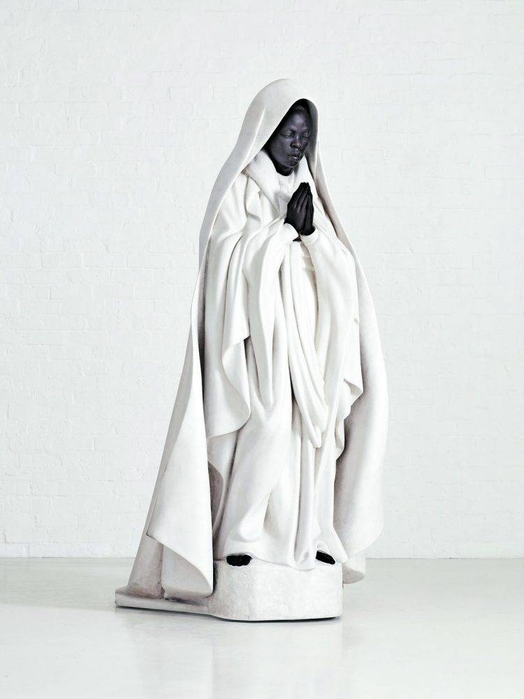 Zanele Muholi's sculpture Umkhuseli (The Protector), with white cementitious robes hand-formed by Plaster Art around a dark bronze face and praying hands.